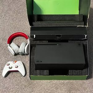 Black Gaming Console with White Controller and Red Headset
